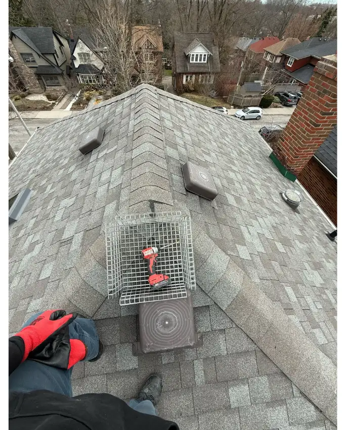 Technician inspecting the exterior of a Toronto house